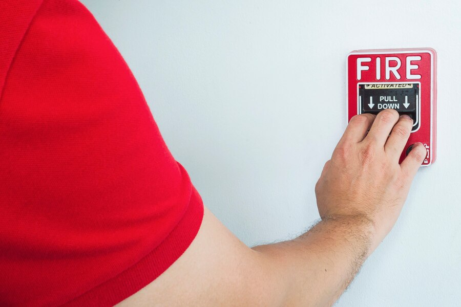 man-is-reaching-his-hand-push-fire-alarm-hand-station_